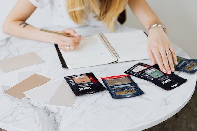 person looking over various paint samples for property improvements