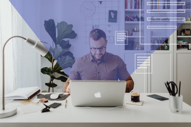 person working on their laptop at their desk