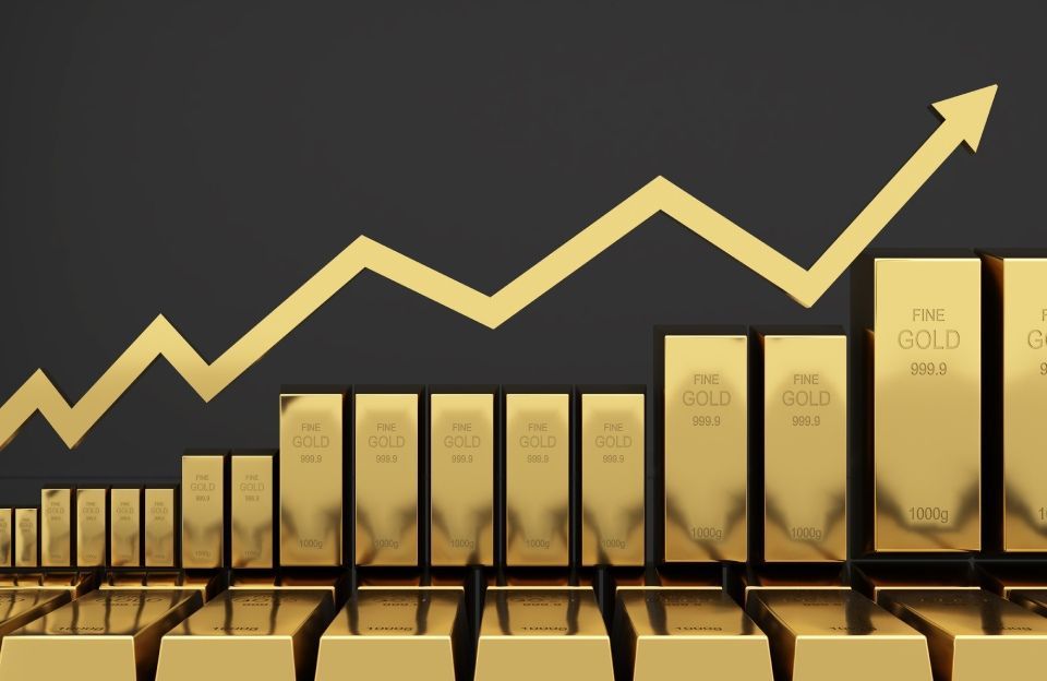 grafico con tendenza in salita e lingotti in oro
