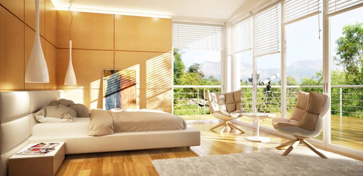 A modern bedroom with large windows featuring blinds pulled up, letting the sun in near Hampton, NH