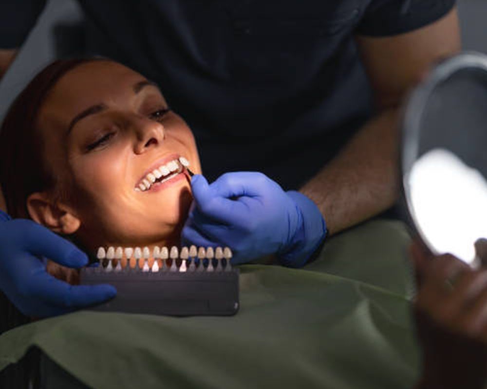 A patient getting professional teeth whitening services A patient getting professional teeth whitening services