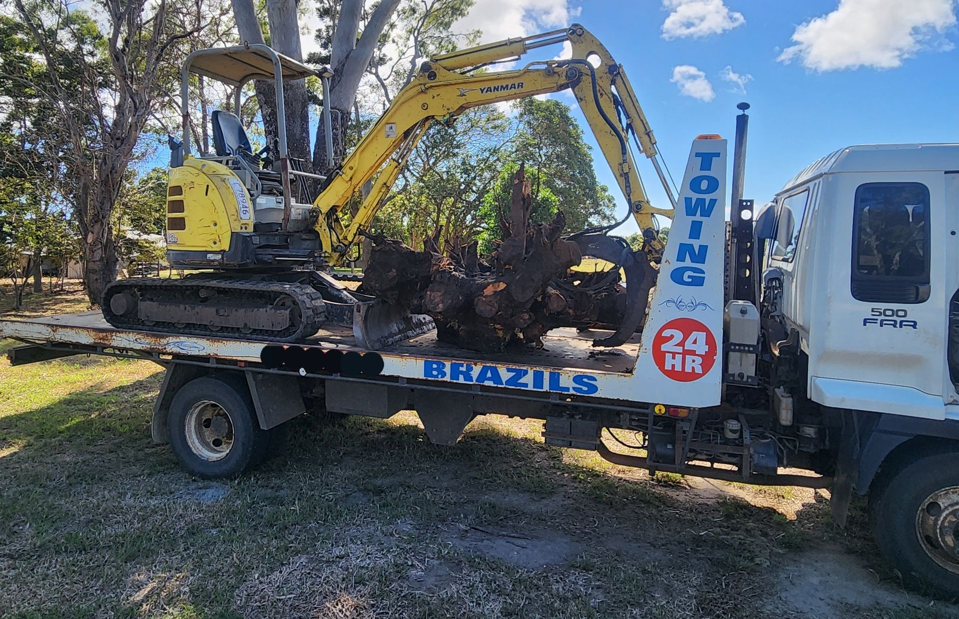 Red Car Being Towed by a White Tow Truck on a Road — DJ Brazil Pty Ltd in Ayr, QLD