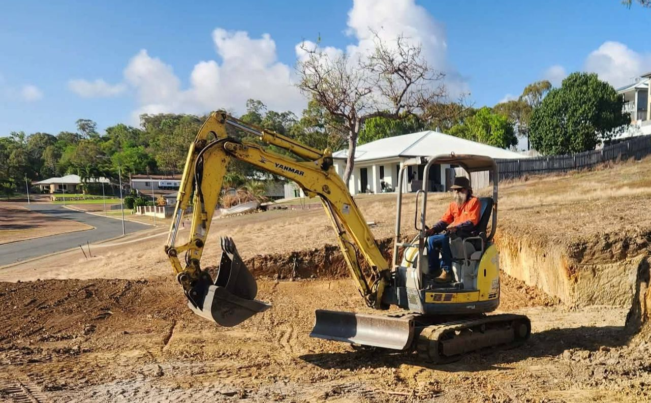 Yellow Excavator Digging Earth — DJ Brazil Pty Ltd in Ayr, QLD