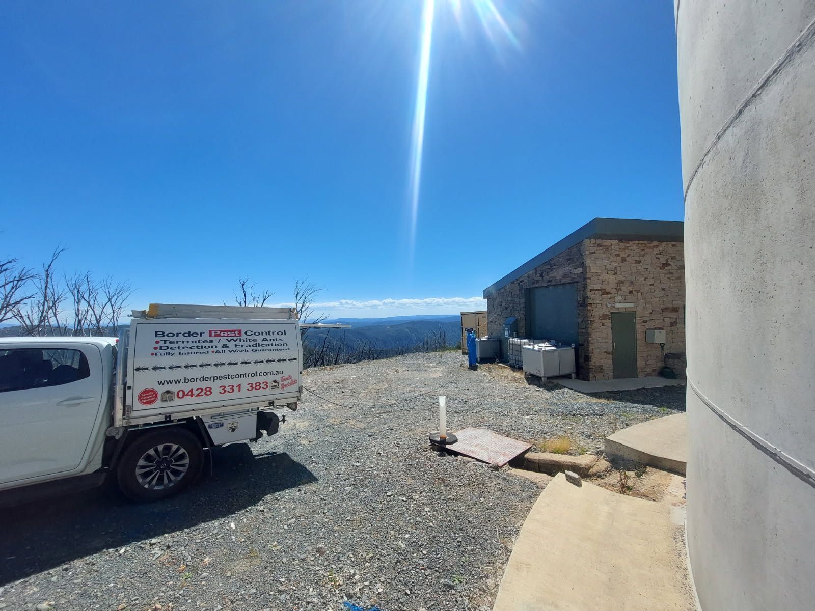 A White Truck is Parked in a Gravel Lot Next to a Building — Border Pest Control In Albury, NSW