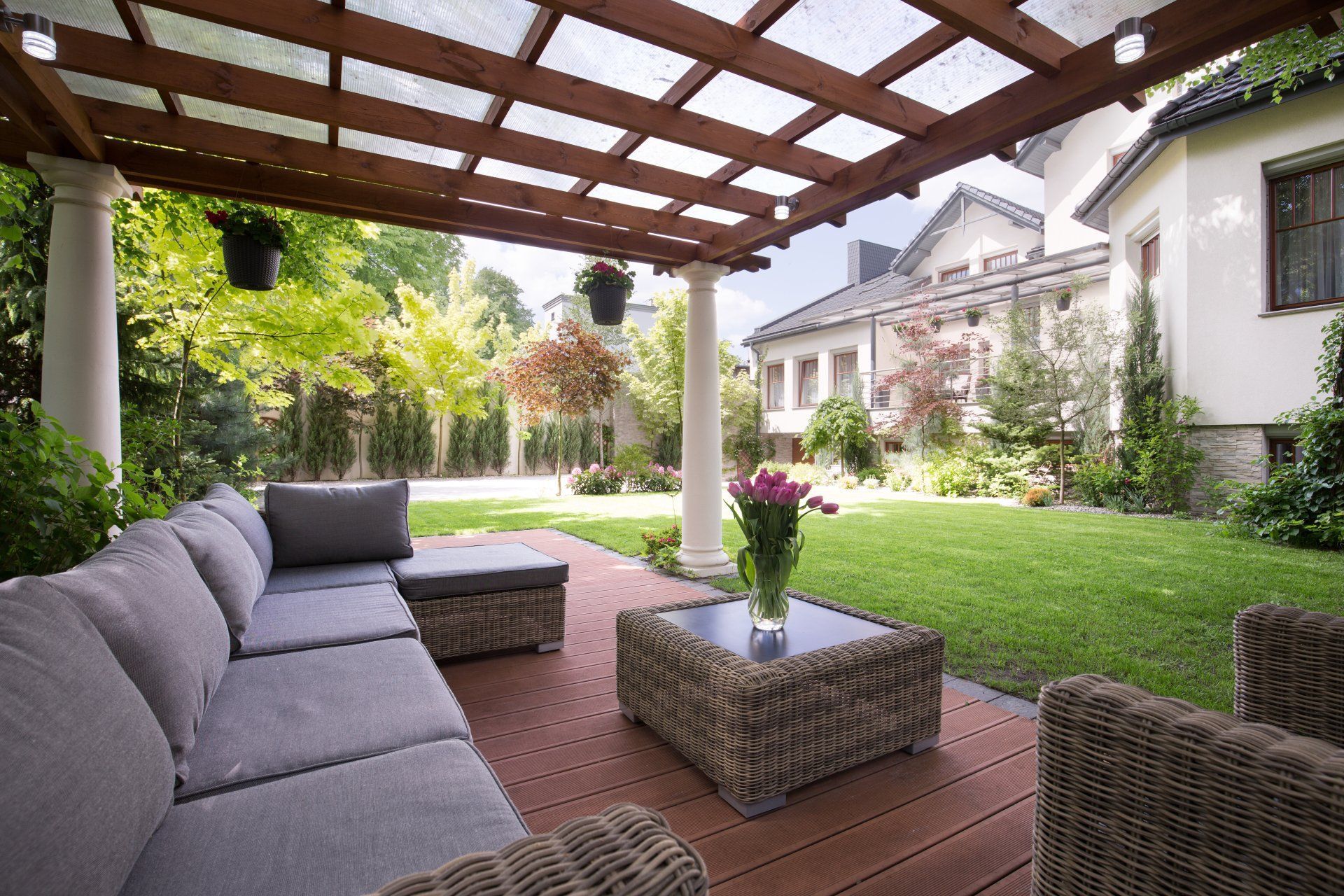 A Patio With a Couch , Chairs and a Table Under a Pergola — Border Pest Control In Albury, NSW