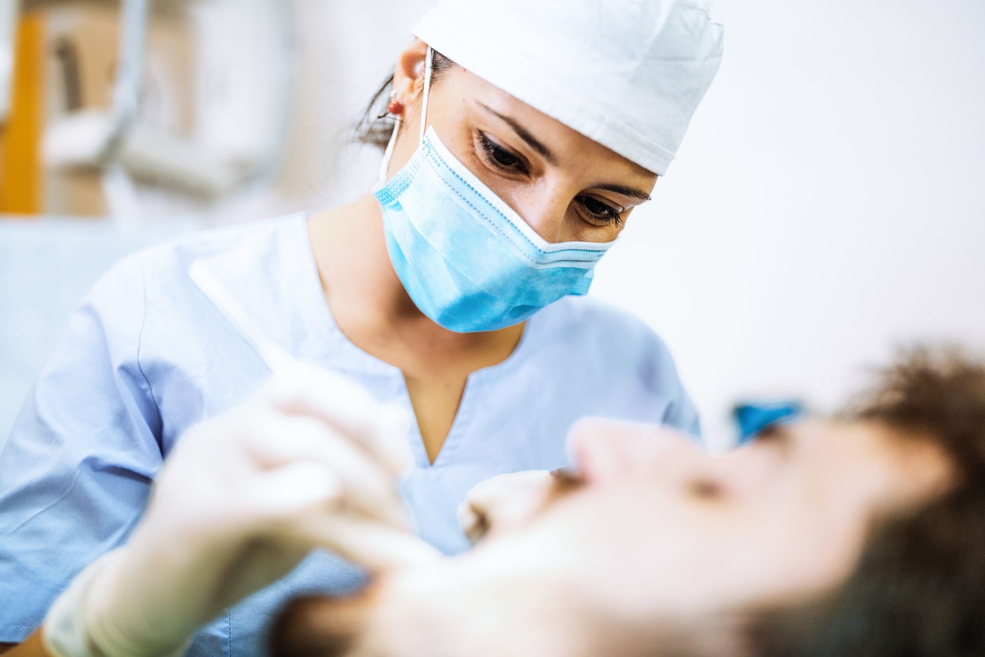 A close-up of a dentist working on a patient’s mouth at the dental clinic. A close-up of a dentist working on a patient’s mouth at the dental clinic.