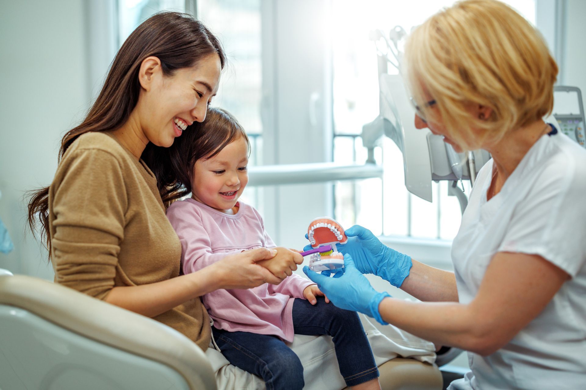 Paediatric Dentist Explaning Mother & Child