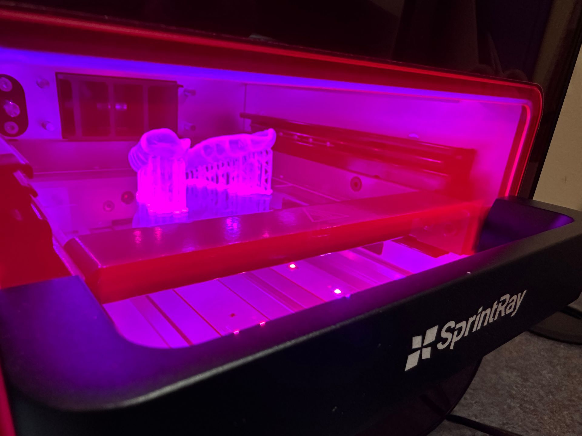 A close up of a model of a tooth being scanned by a machine.