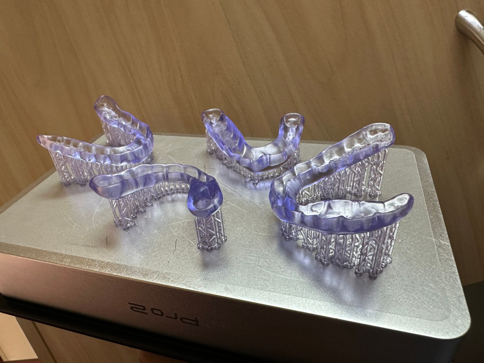A dentist is working on a model of a person 's teeth.