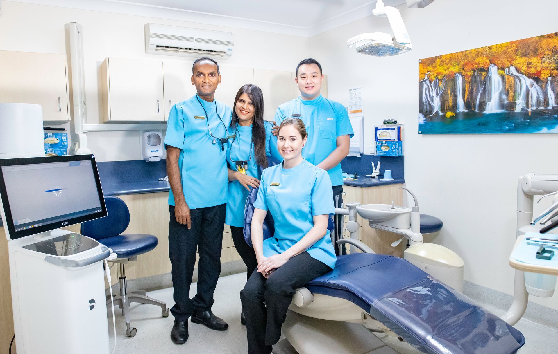 A woman is getting her teeth whitened by a dentist in a dental office.