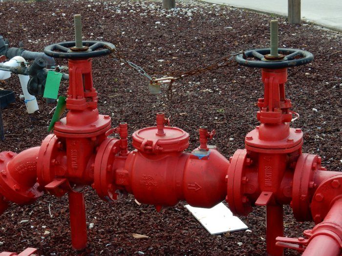 A Bunch Of Red Pipes And Valves — Christians Plumbing in Emerald, QLD
