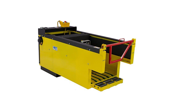 A yellow and black box with a red handle on a white background.