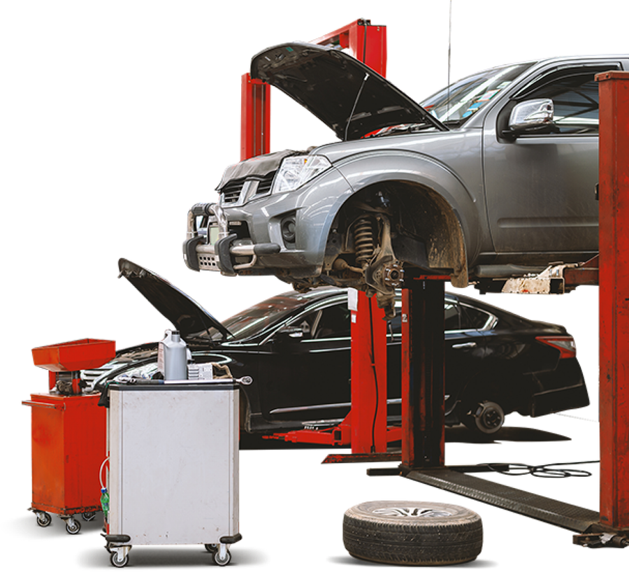 Car lifted on red auto lift in a repair shop, hood open, with tools and spare tire nearby | PC Auto Repair