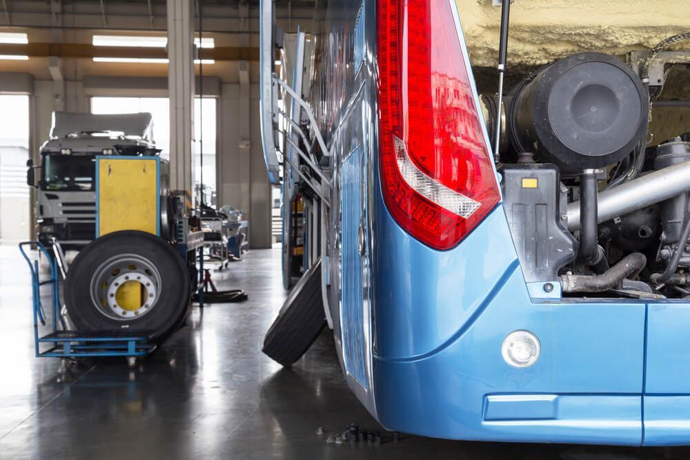 A Blue Bus is Being Repaired in a Garage — Reliable Bus and Truck Repairs In Caloundra West, QLD
