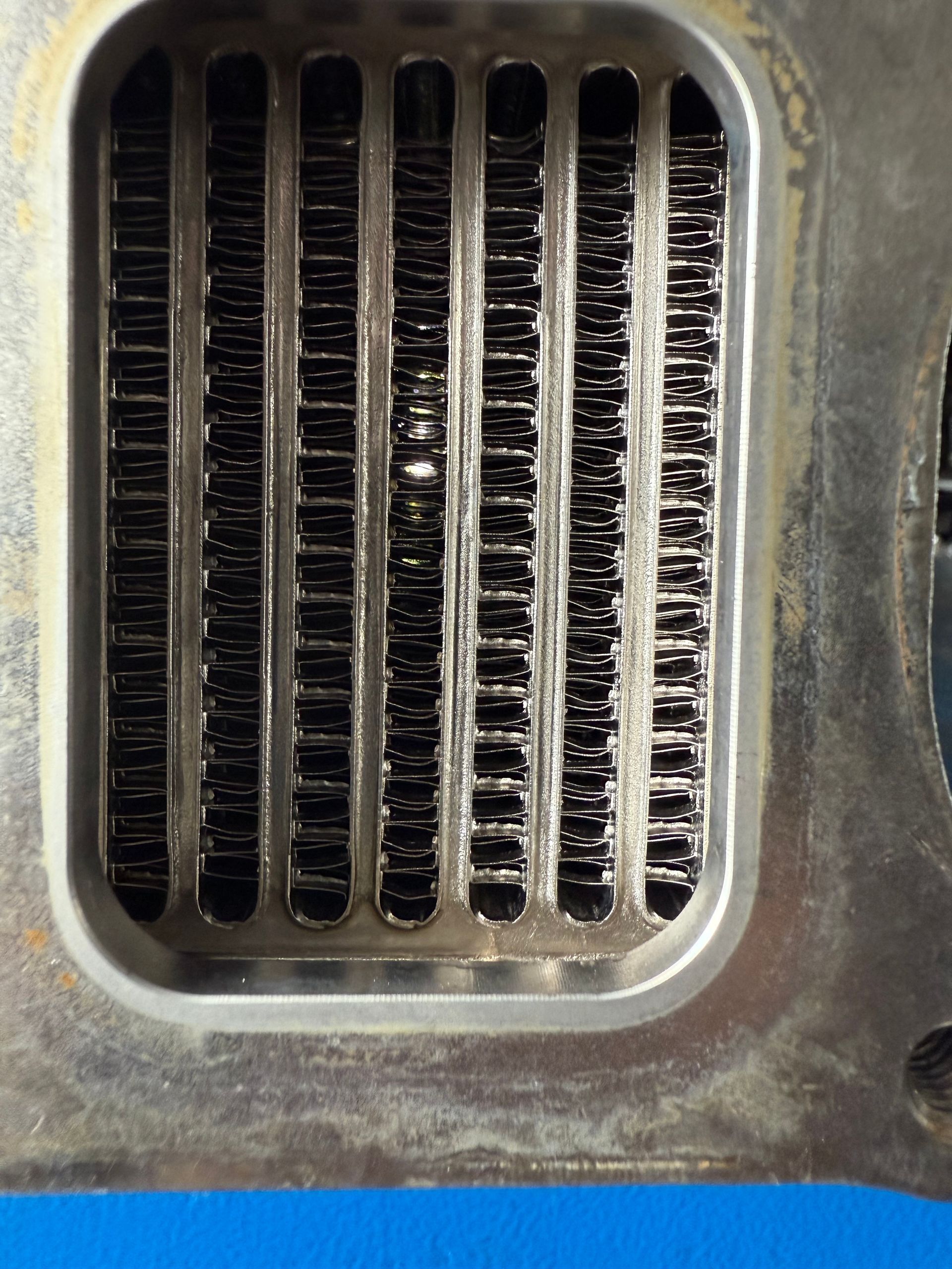 Close-up of a Weathered Metal Grille With Vertical Slats — Reliable Bus and Truck Repairs In Caloundra West, QLD