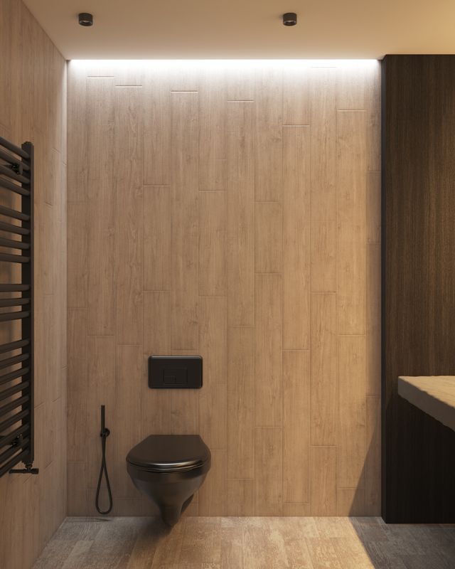 Modern bathroom with a wall-mounted toilet, wood tile walls, and soft overhead lighting.