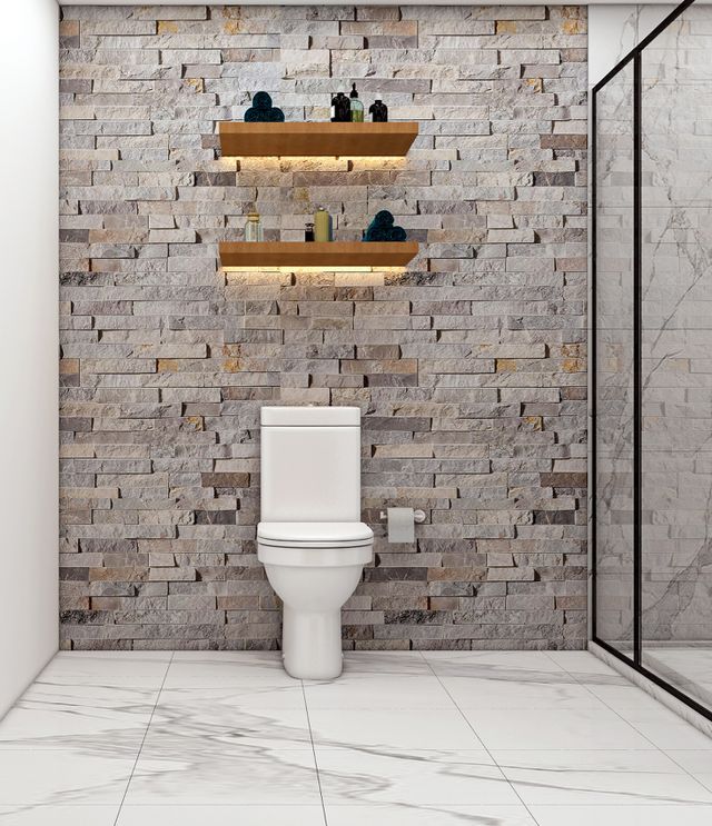 Modern bathroom with white toilet, stone accent wall, floating shelves, and glass shower enclosure