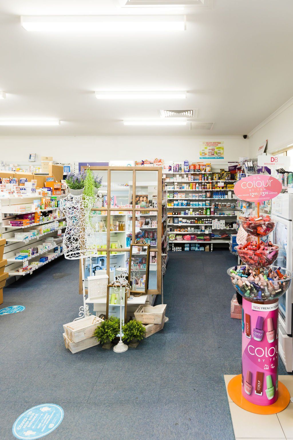 Bright convenience store aisle with shelves of snacks, drinks, and gift displays under fluorescent lights