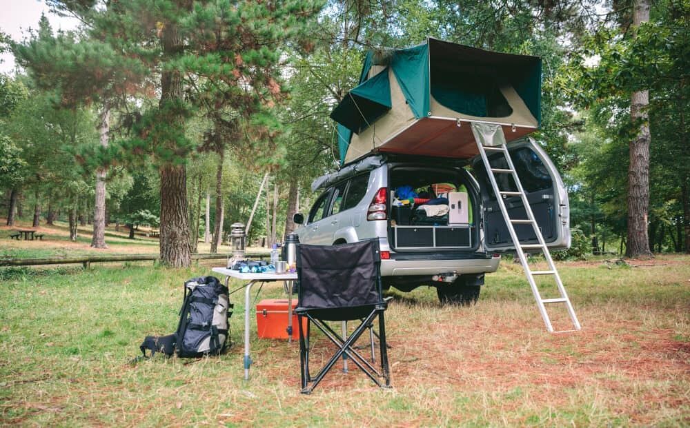 SUV With Rooftop Tent Set Up for Camping in a Wooded Area — Track N Back 4x4 In Port Douglas, QLD