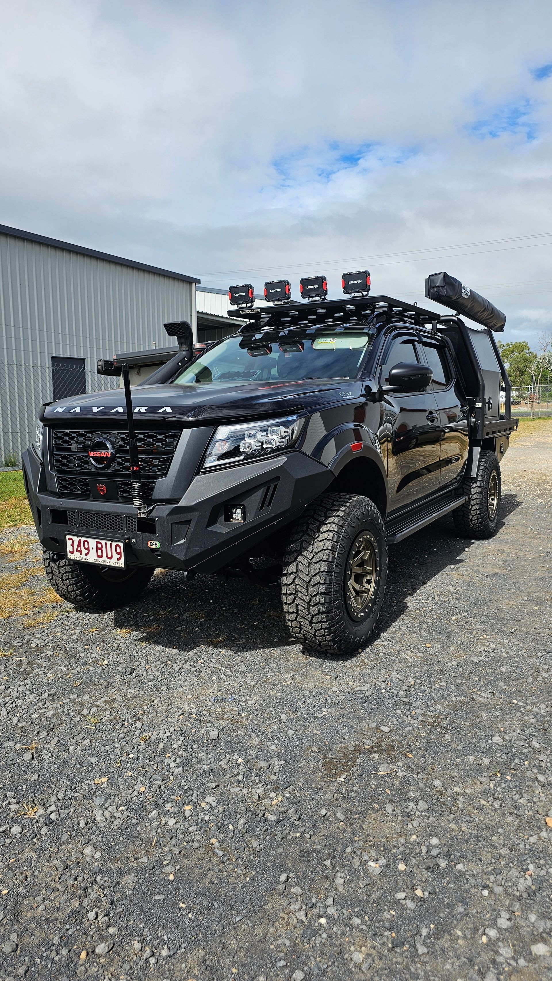 Black off-road Truck With Large Tires, Roof Rack, and Accessories — Track N Back 4x4 In Mareeba, QLD