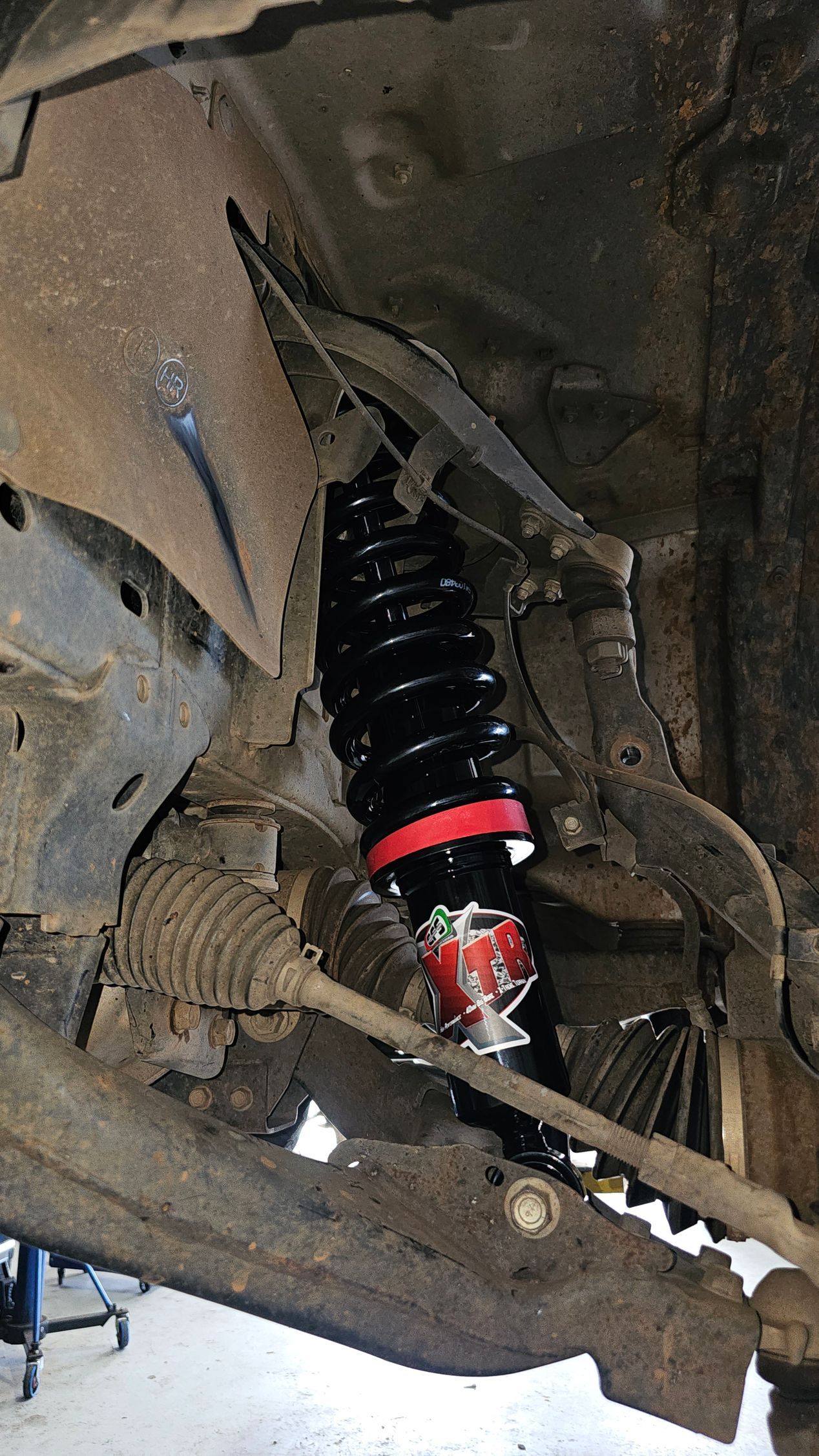 Black and Red Shock Absorber Installed on a Vehicle's Suspension — Track N Back 4x4 In Mareeba, QLD