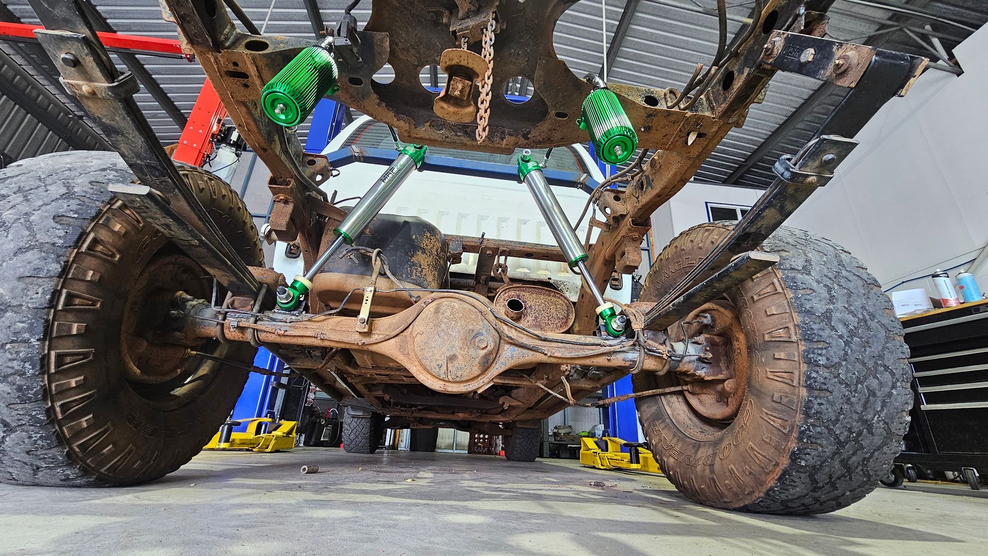 Underside View of a Rusty 4x4 Truck Chassis With Mud-covered Tires — Track N Back 4x4 In Mareeba, QLD