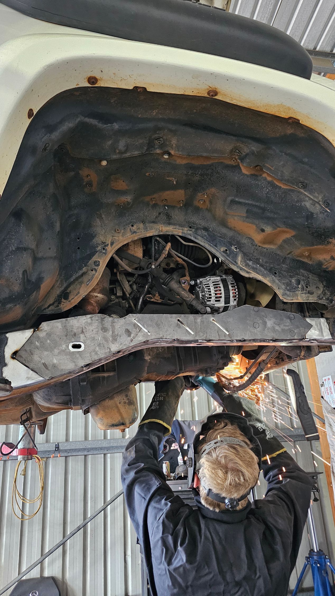 A Person Welding a Car's Underside, Sparks Flying — Track N Back 4x4 In Mareeba, QLD