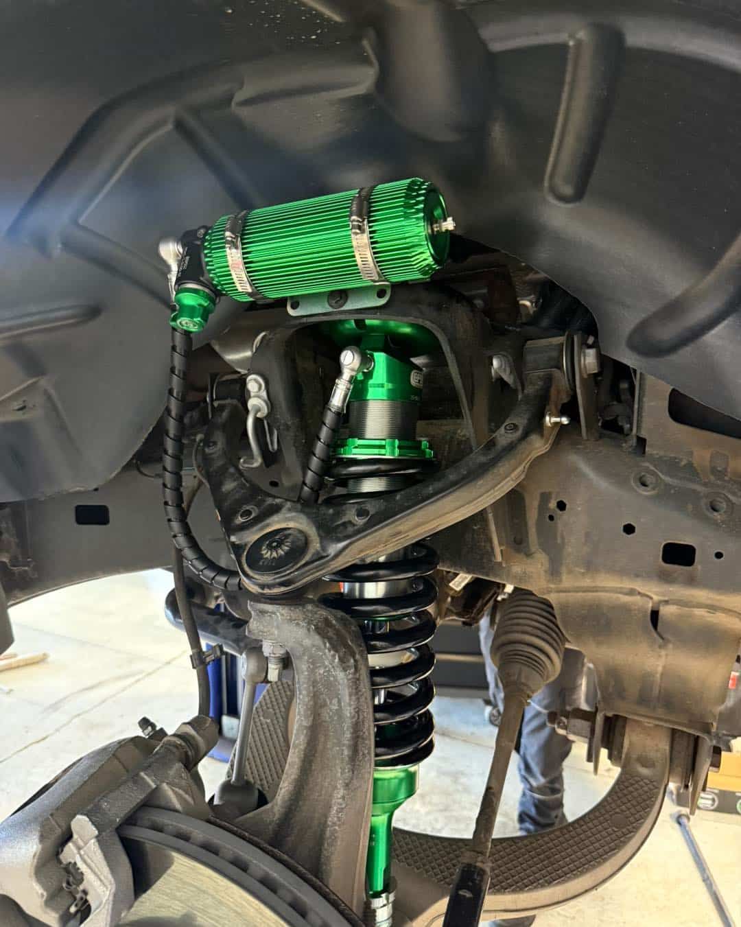 Green and Black Vehicle Suspension System With a Coil-over Shock — Track N Back 4x4 In Normanton, QLD