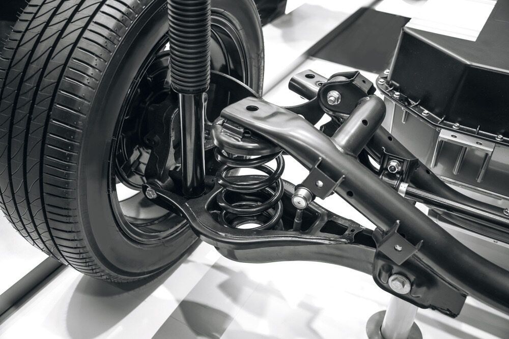 Black and White Close-up of a Car's Rear Suspension System — Track N Back 4x4 In Townsville, QLD