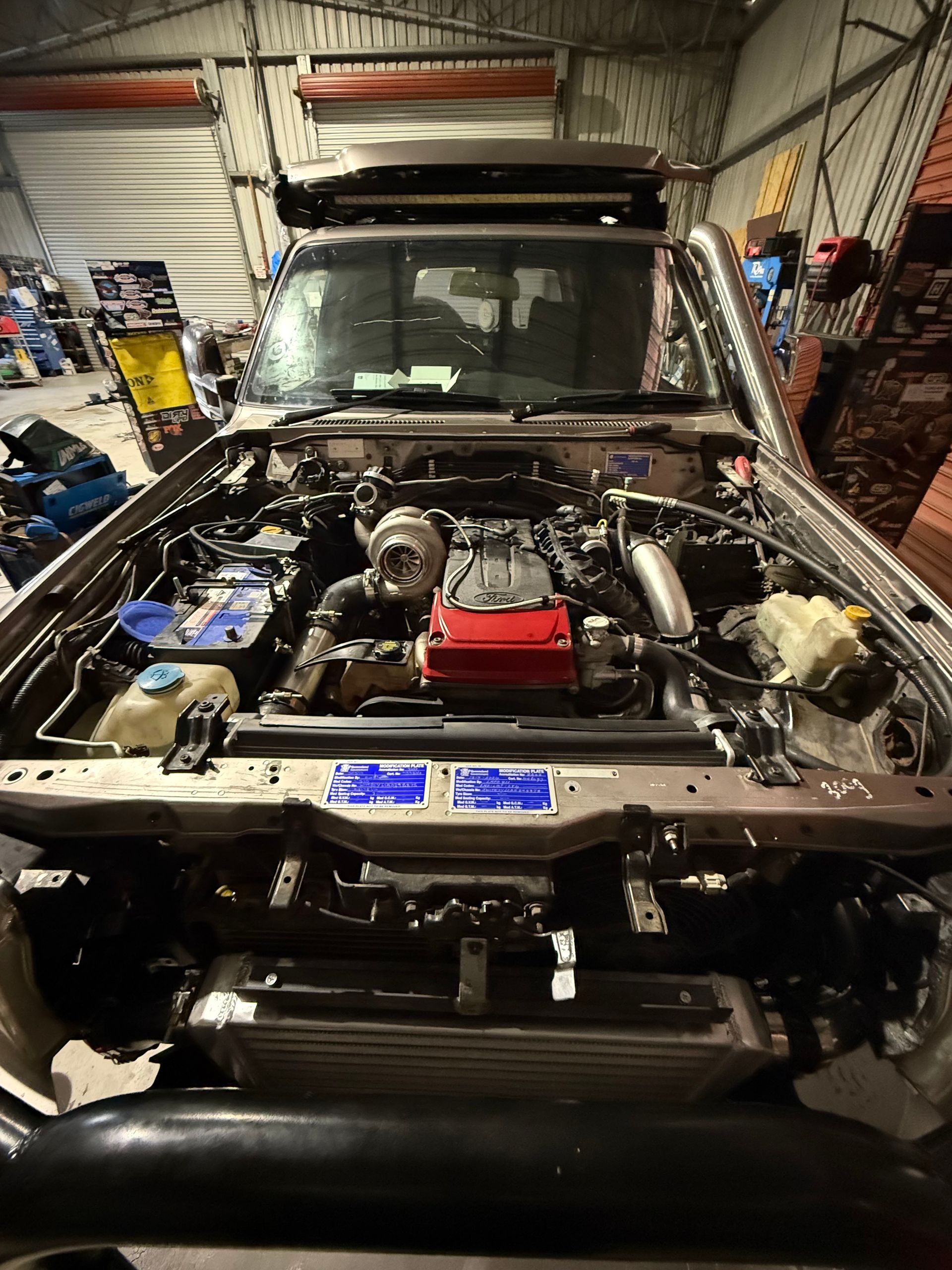 Open Engine Bay of a Modified, Silver 4x4 Truck — Track N Back 4x4 In Mareeba, QLD