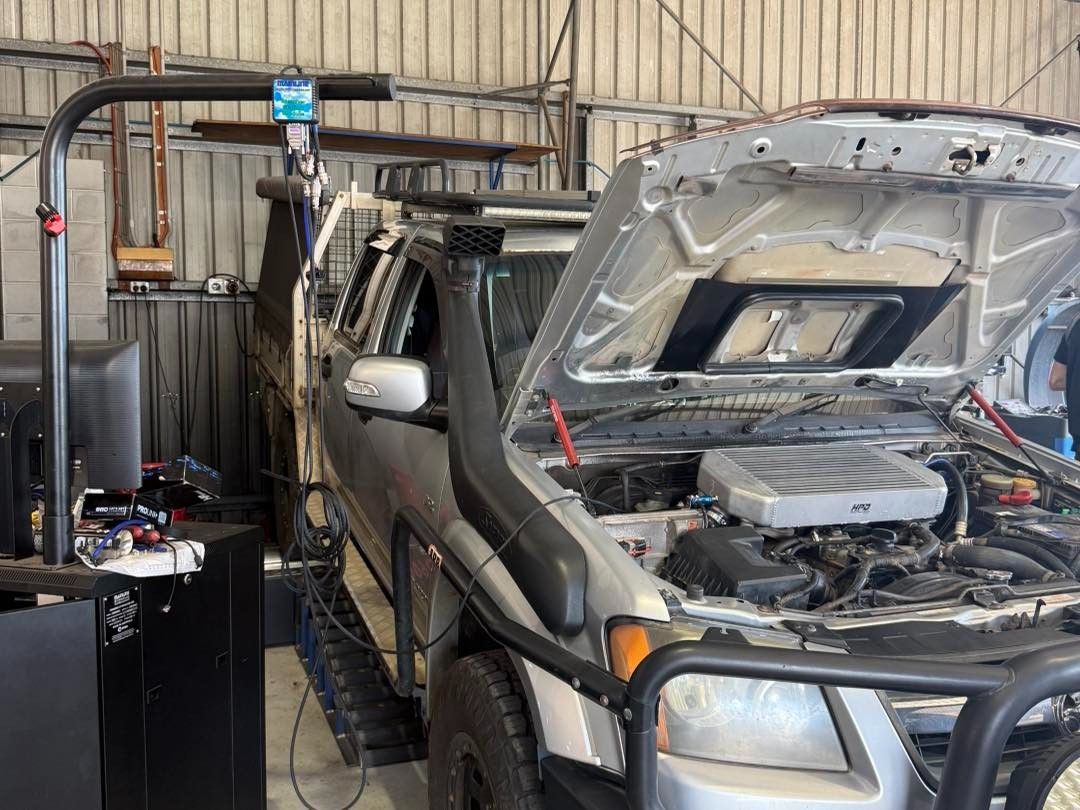 White Car on a Dynamometer, Testing the Engine With Spinning Tire — Track N Back 4x4 In Townsville, QLD