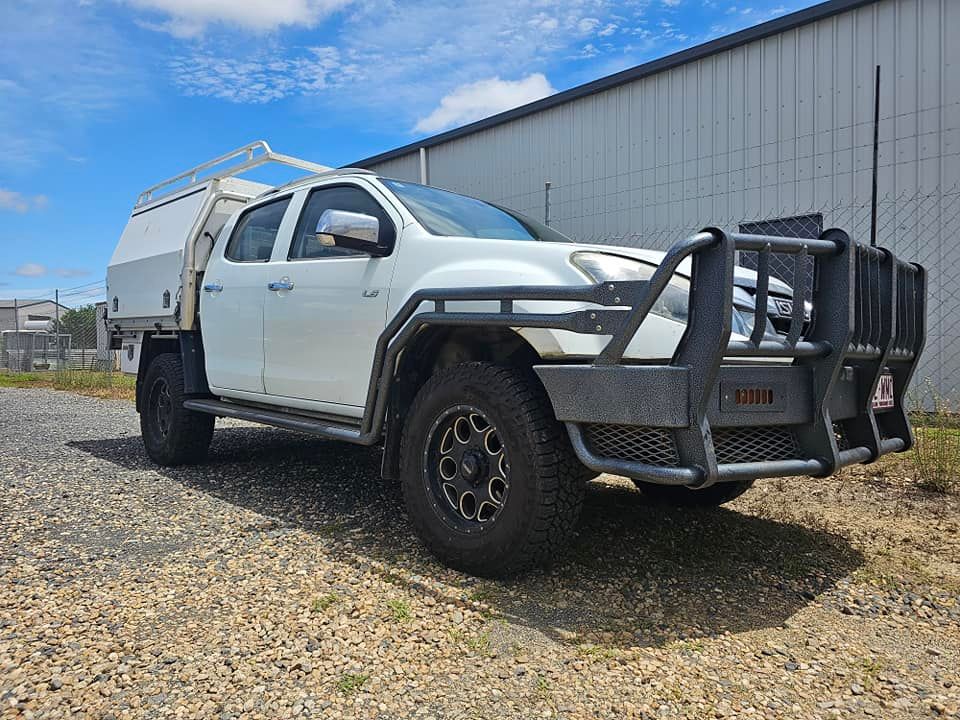 Black Truck on a Lift in a Garage, Showing Front Tire and Side — Track N Back 4x4 In Mareeba, QLD