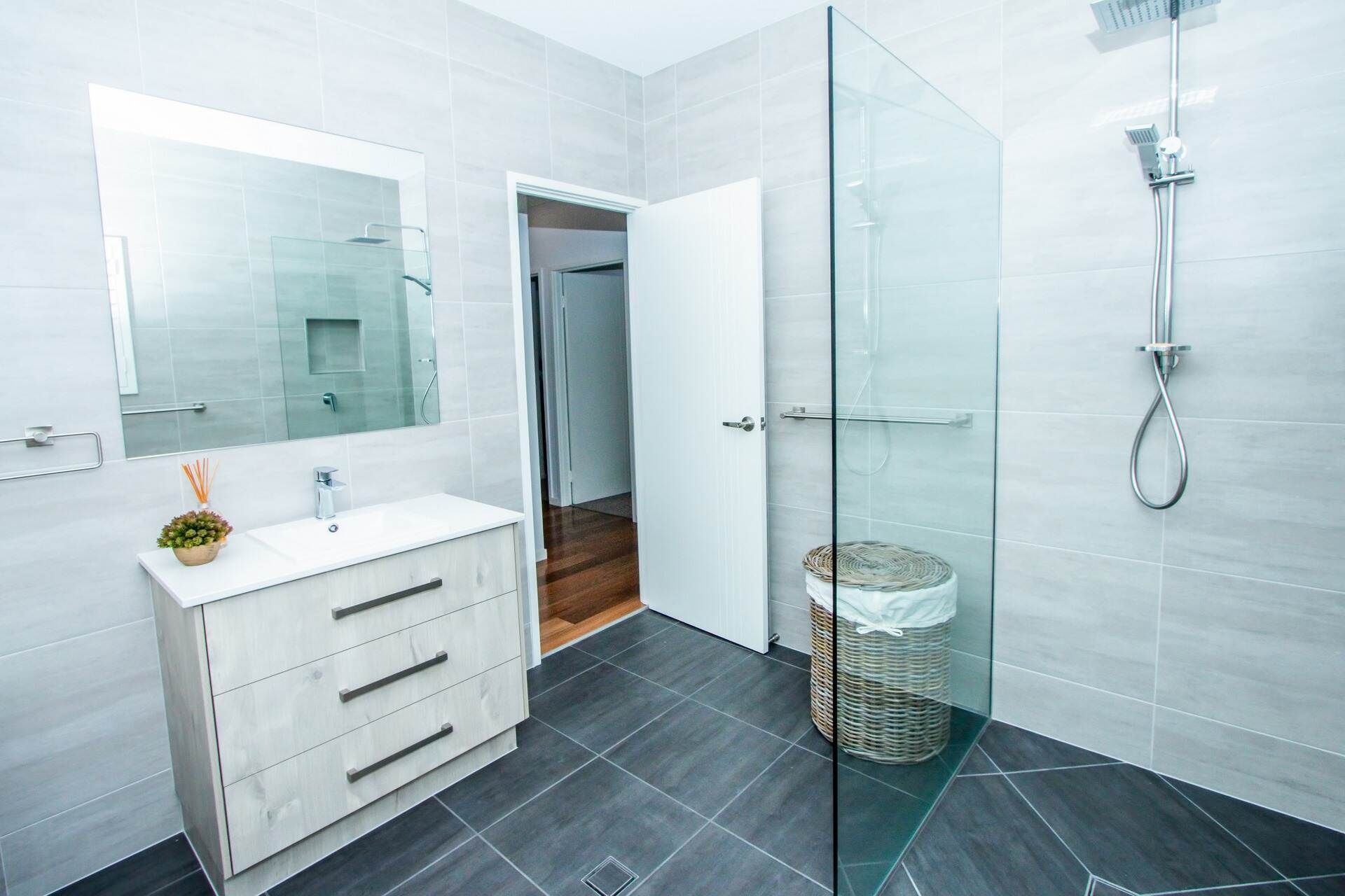 A Bathroom With a Sink, Mirror and Walk in Shower — Regalline Cabinets & Joinery in Svensson Heights, QLD
