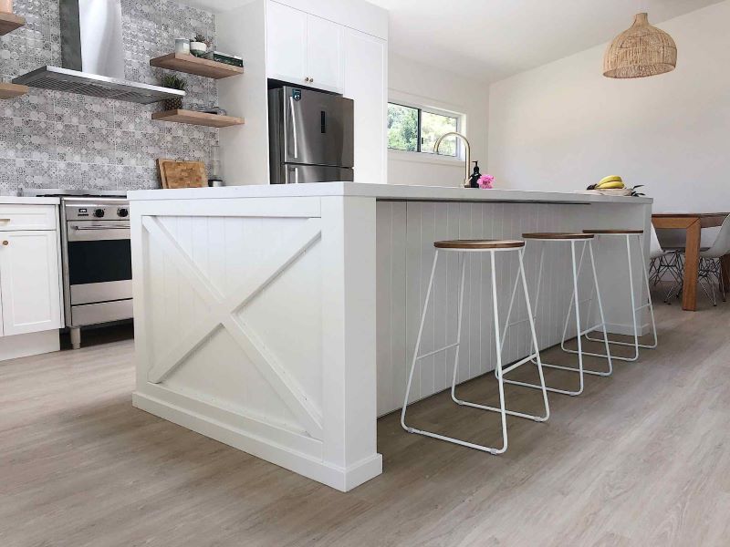 A Kitchen With a Large Island and Stools — Regalline Cabinets & Joinery in Svensson Heights, QLD