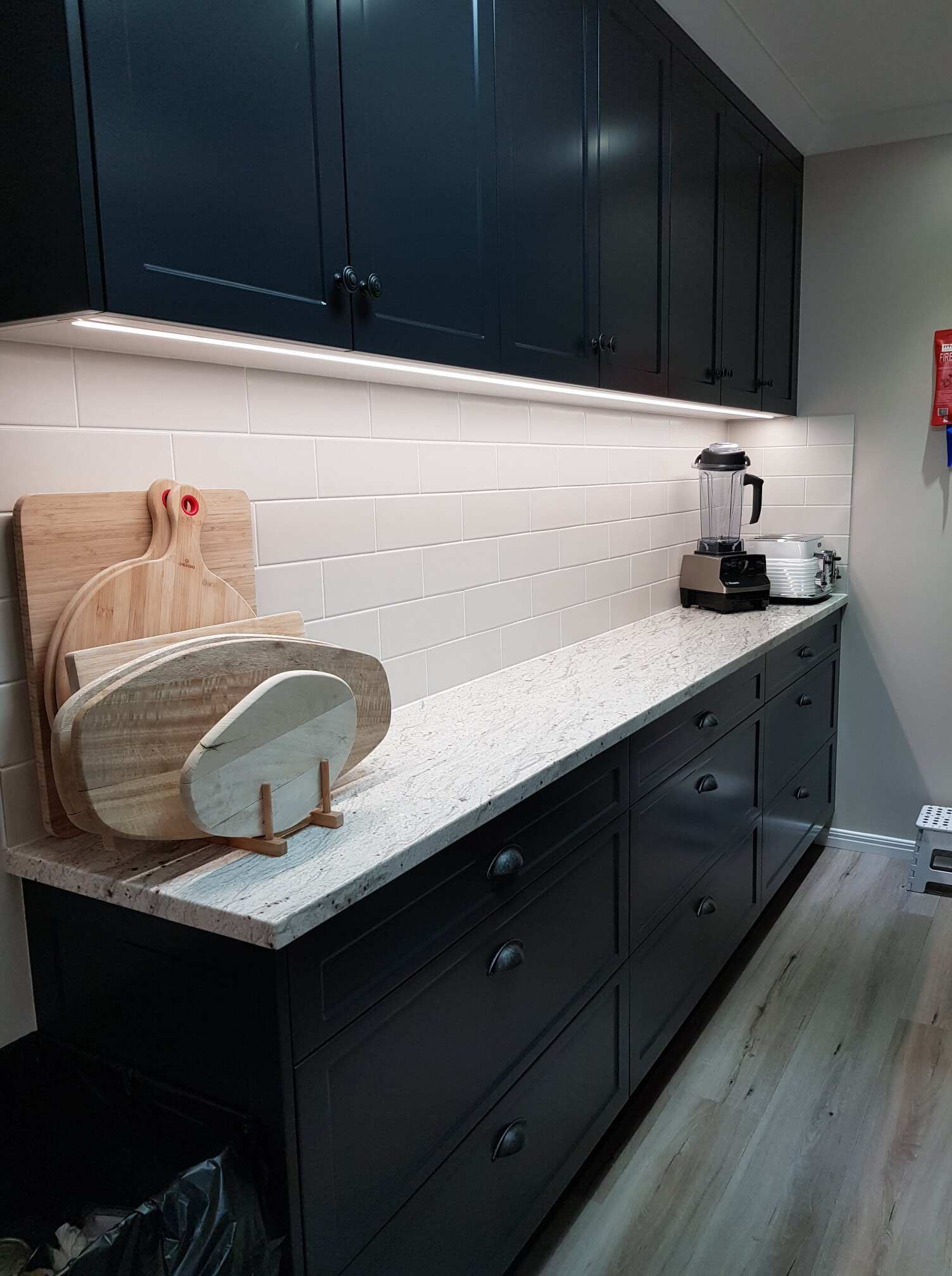 A Kitchen With Black Cabinets and White Counter Tops — Regalline Cabinets & Joinery in Svensson Heights, QLD