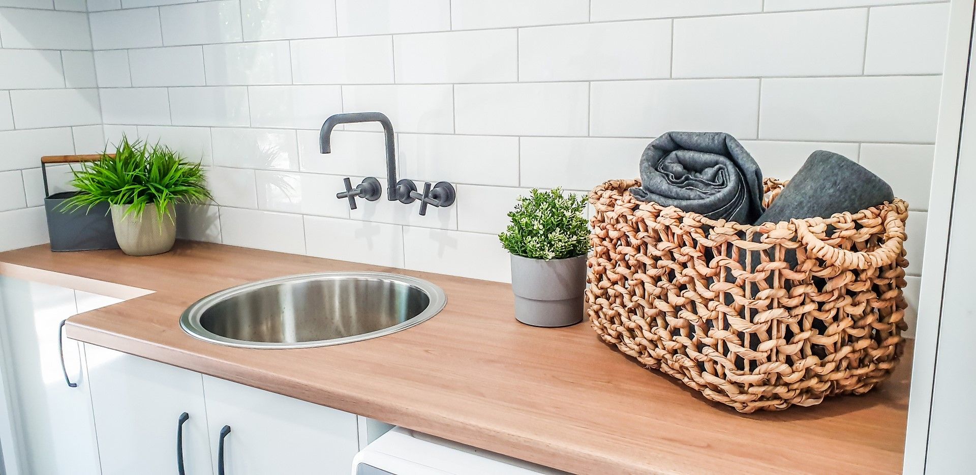 A Laundry Room With a Washer and Dryer and a Sink — Regalline Cabinets & Joinery in Svensson Heights, QLD