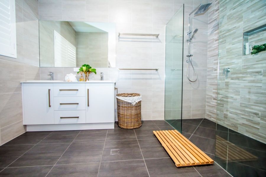 A bathroom with a walk in shower and a sink.