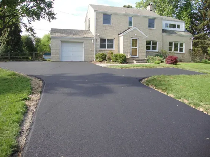 A house with a garage and a driveway in front of it
