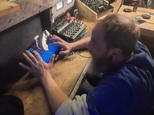 A man is sitting at a desk using a tablet computer.