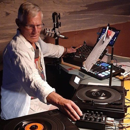 A man is playing a record on a turntable