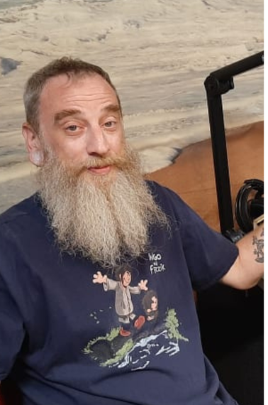 A man with a beard is wearing a shirt that says mad fish