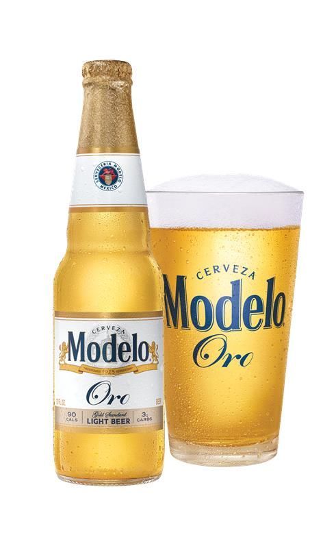 Modelo Oro beer bottle and glass of golden beer on a white background