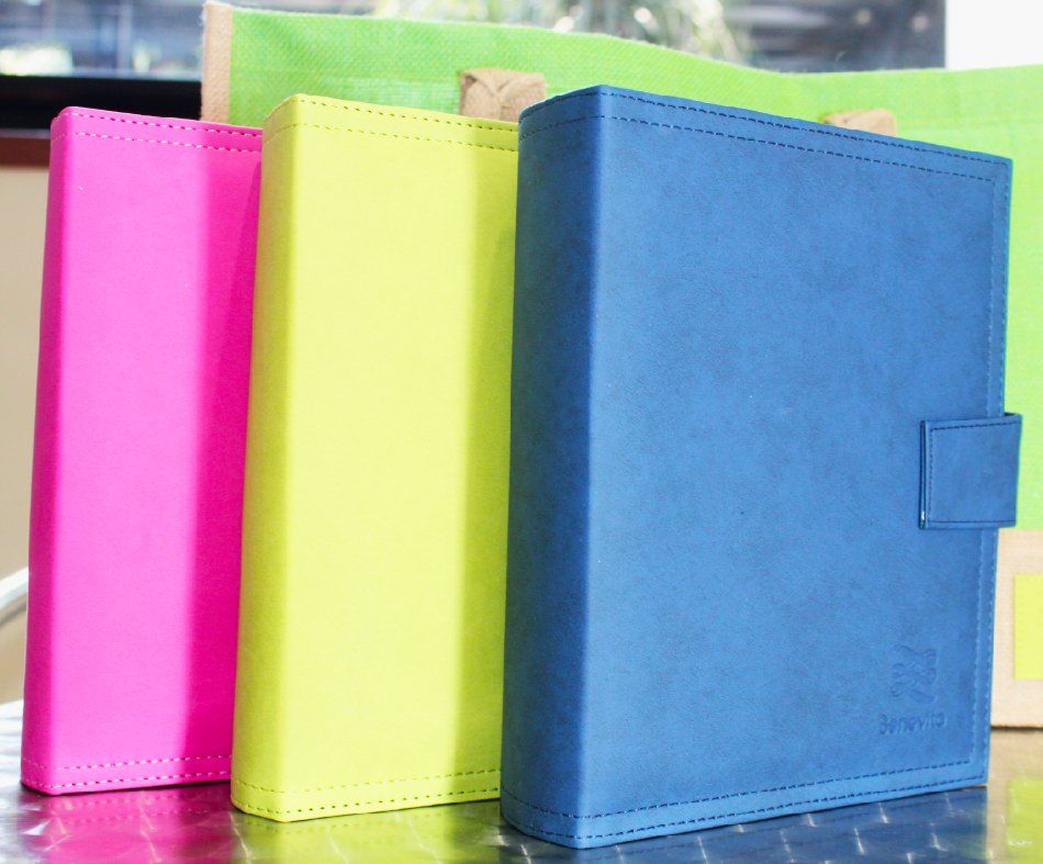Three brightly colored books are stacked on top of each other