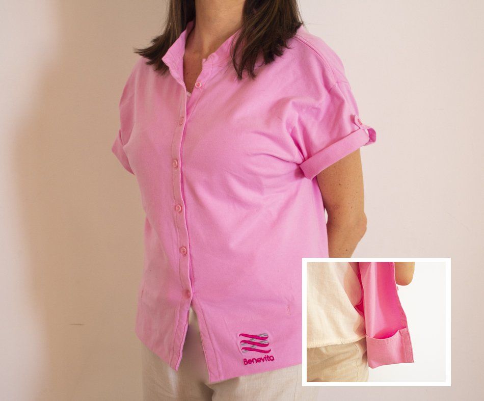 A woman wearing a pink shirt with the word bravo on it