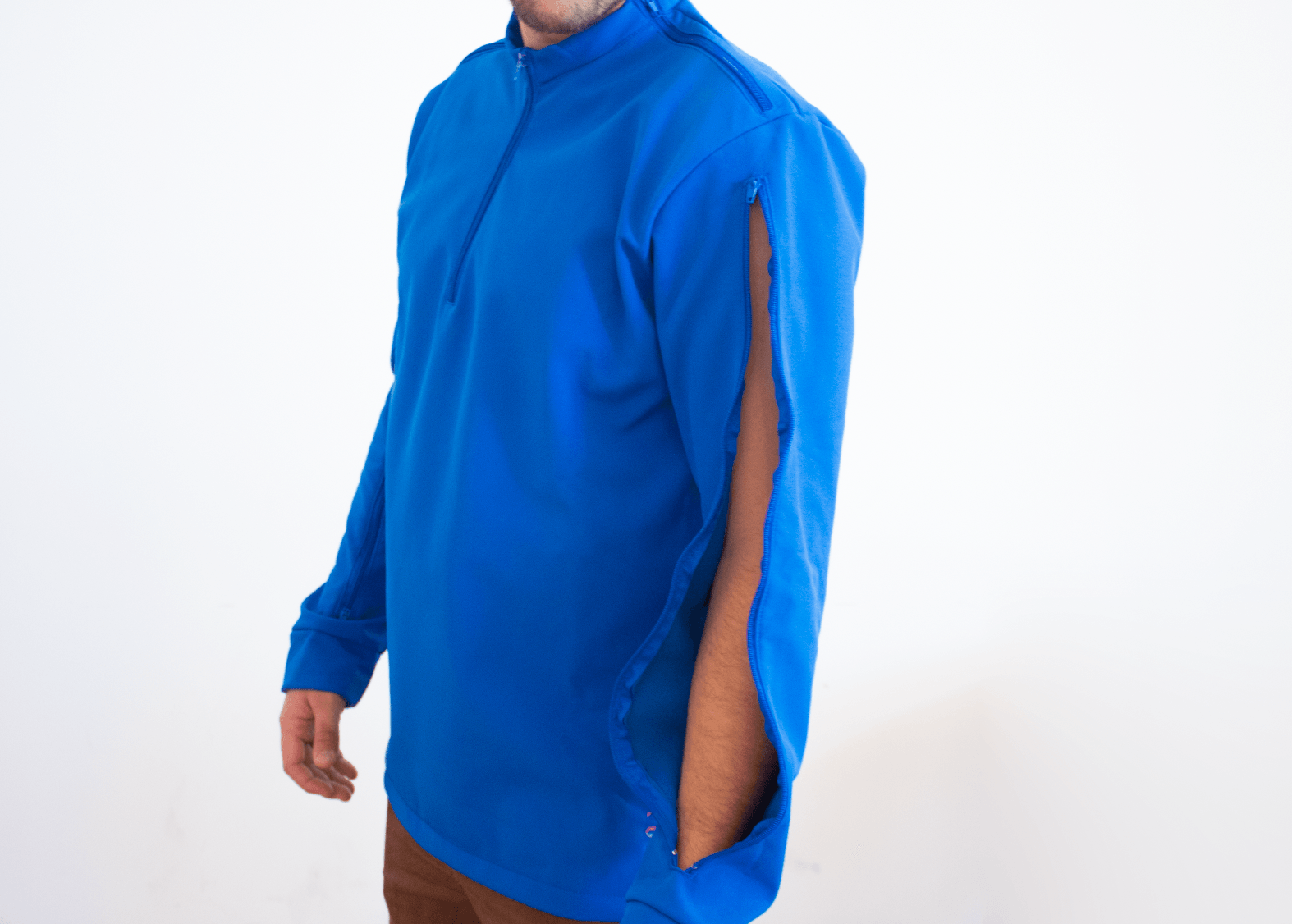 A man wearing a blue shirt with a zipper on the side