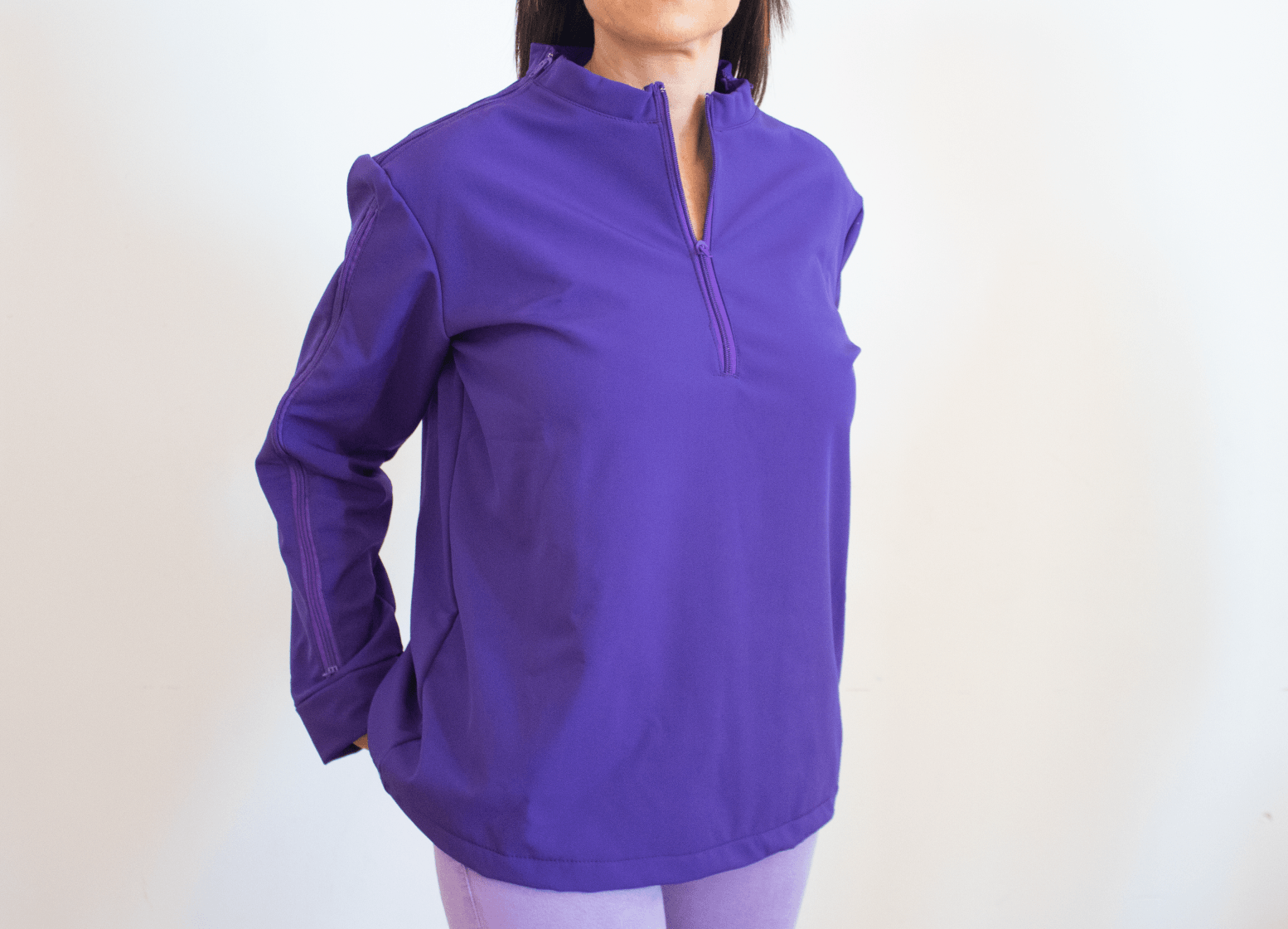 A woman is wearing a purple shirt and purple pants.