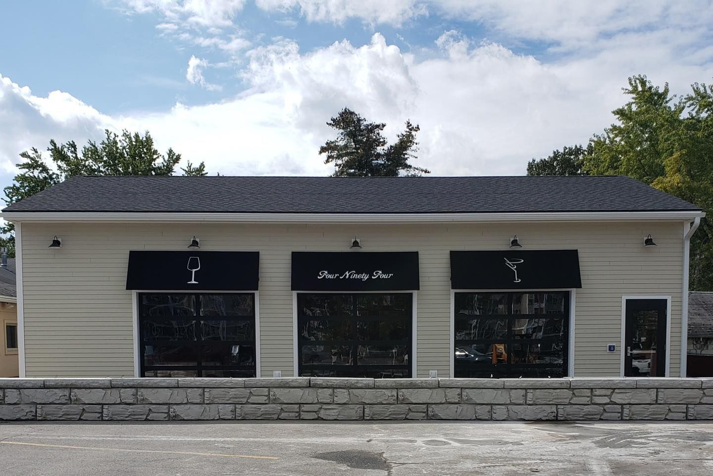 A white building with a black awning that says ' y ' on it