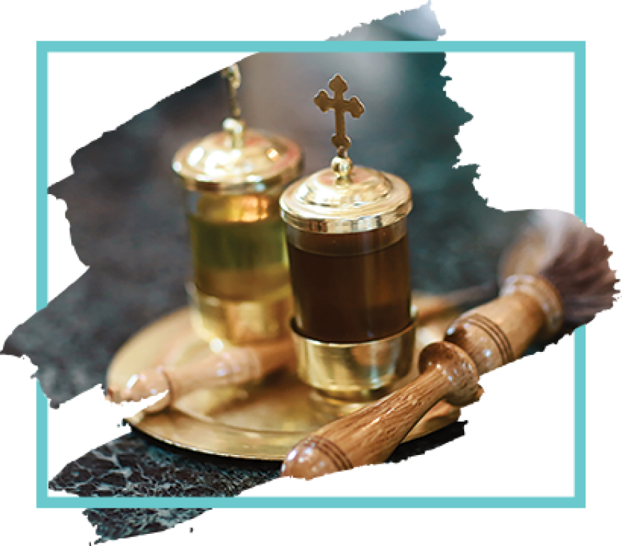 Orthodox communion set with golden chalices, cross lid, spoon, and tray on a dark cloth