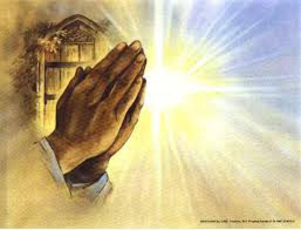 Hands clasped in prayer beside a bright glowing light and a small church silhouette