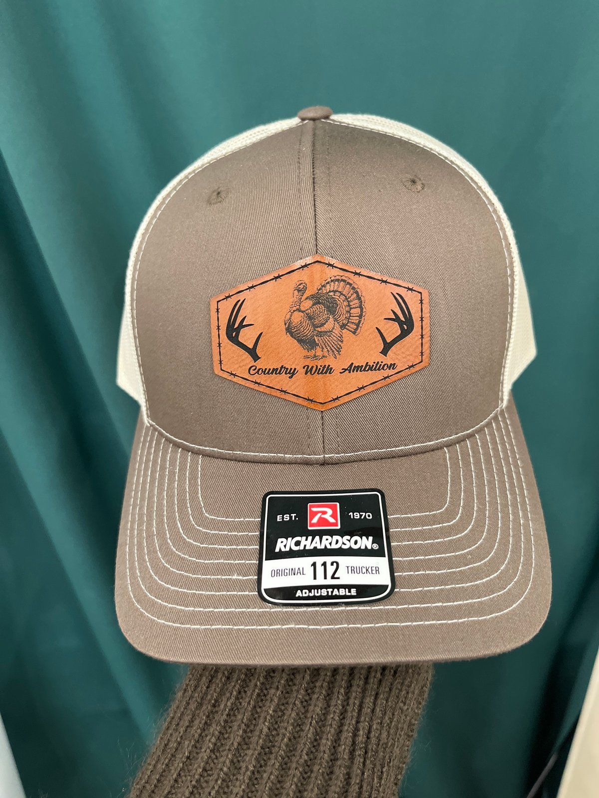 Brown and cream Richardson trucker hat with turkey leather patch